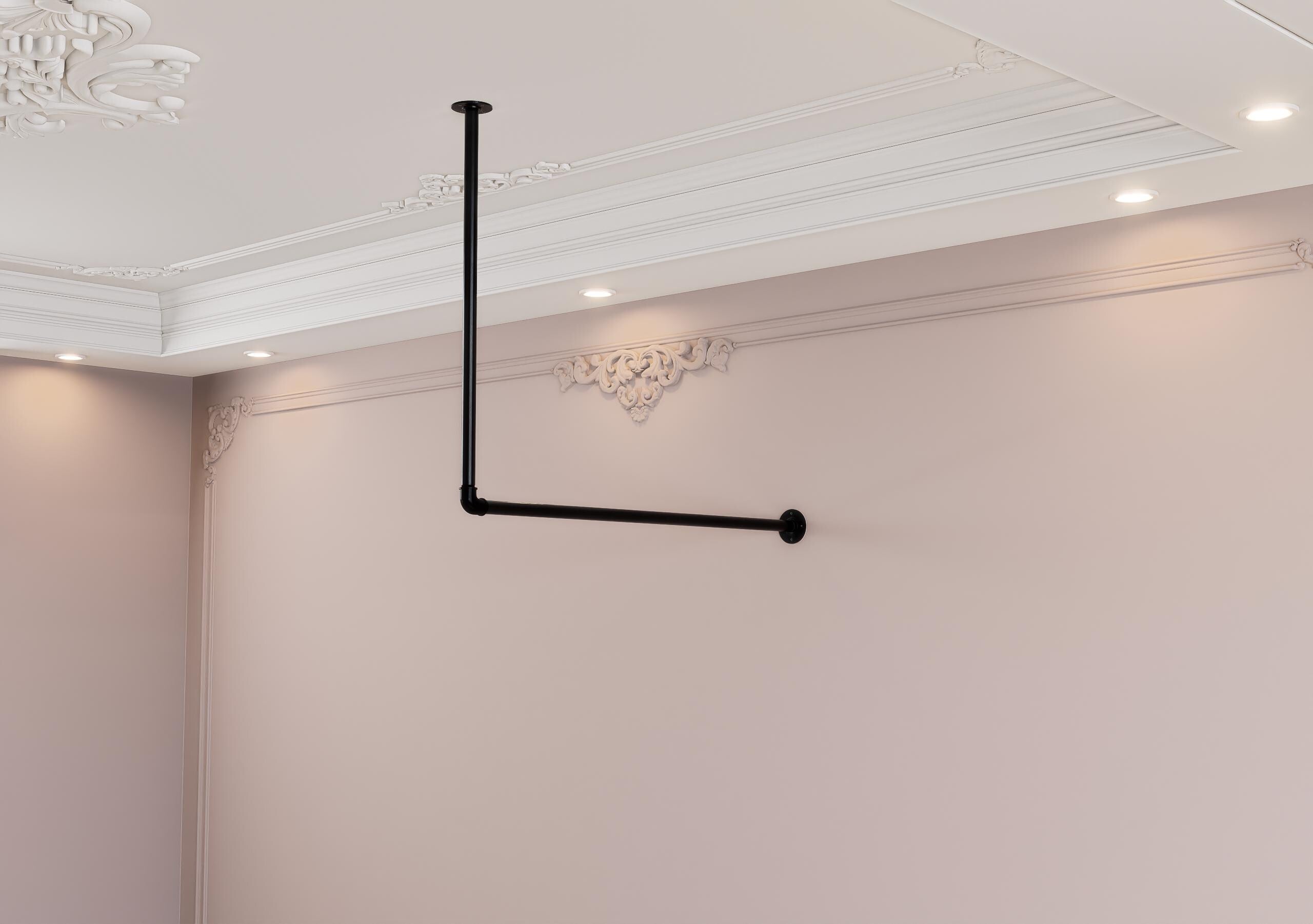 a white room with a black pipe on the wall