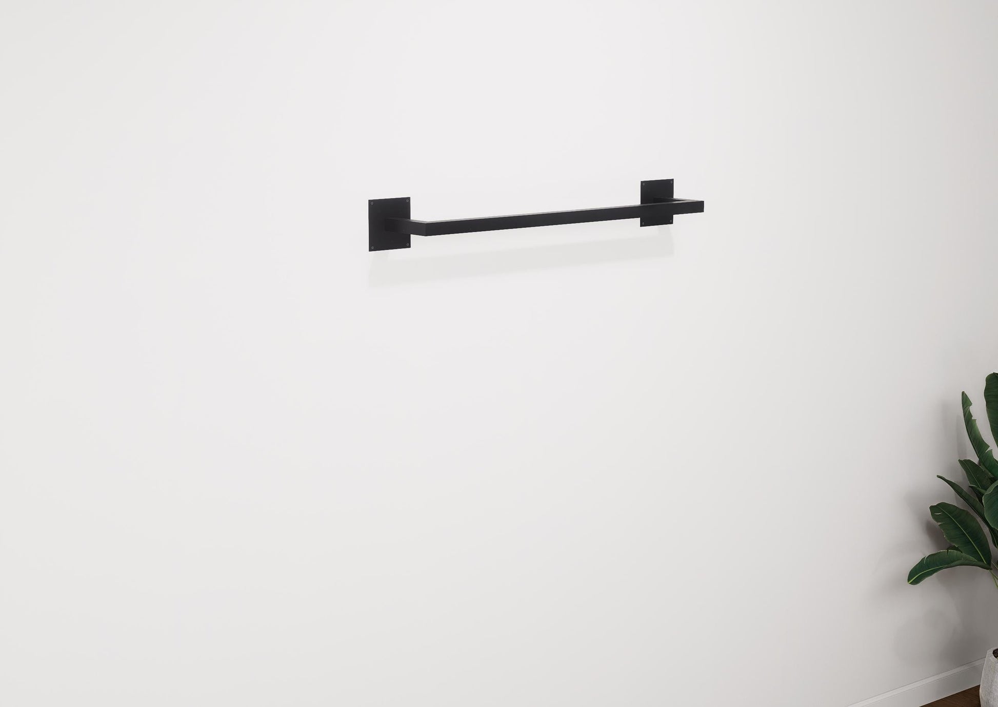 Minimalist square towel holder made from sturdy metal, featuring an industrial design. Ideal for organizing towels in the bathroom, adding a modern touch to decor. Durable and easy to install.
