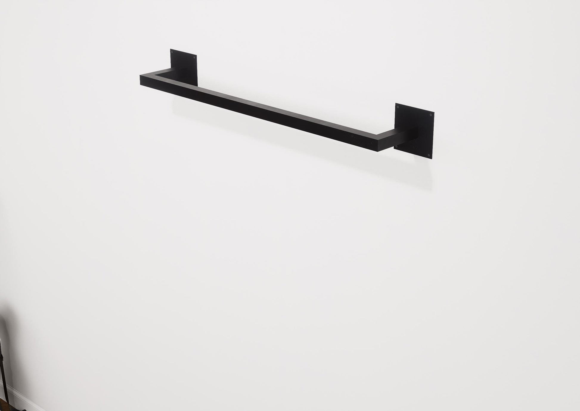 Minimalist square towel holder made from sturdy metal, featuring an industrial design. Ideal for organizing towels in the bathroom, adding a modern touch to decor. Durable and easy to install.