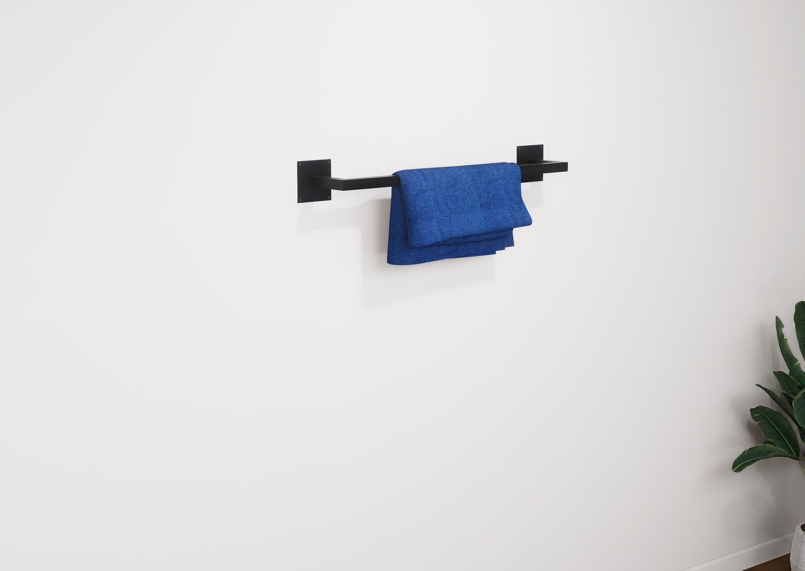 Minimalist square towel holder made from sturdy metal, featuring an industrial design. Ideal for organizing towels in the bathroom, adding a modern touch to decor. Durable and easy to install.