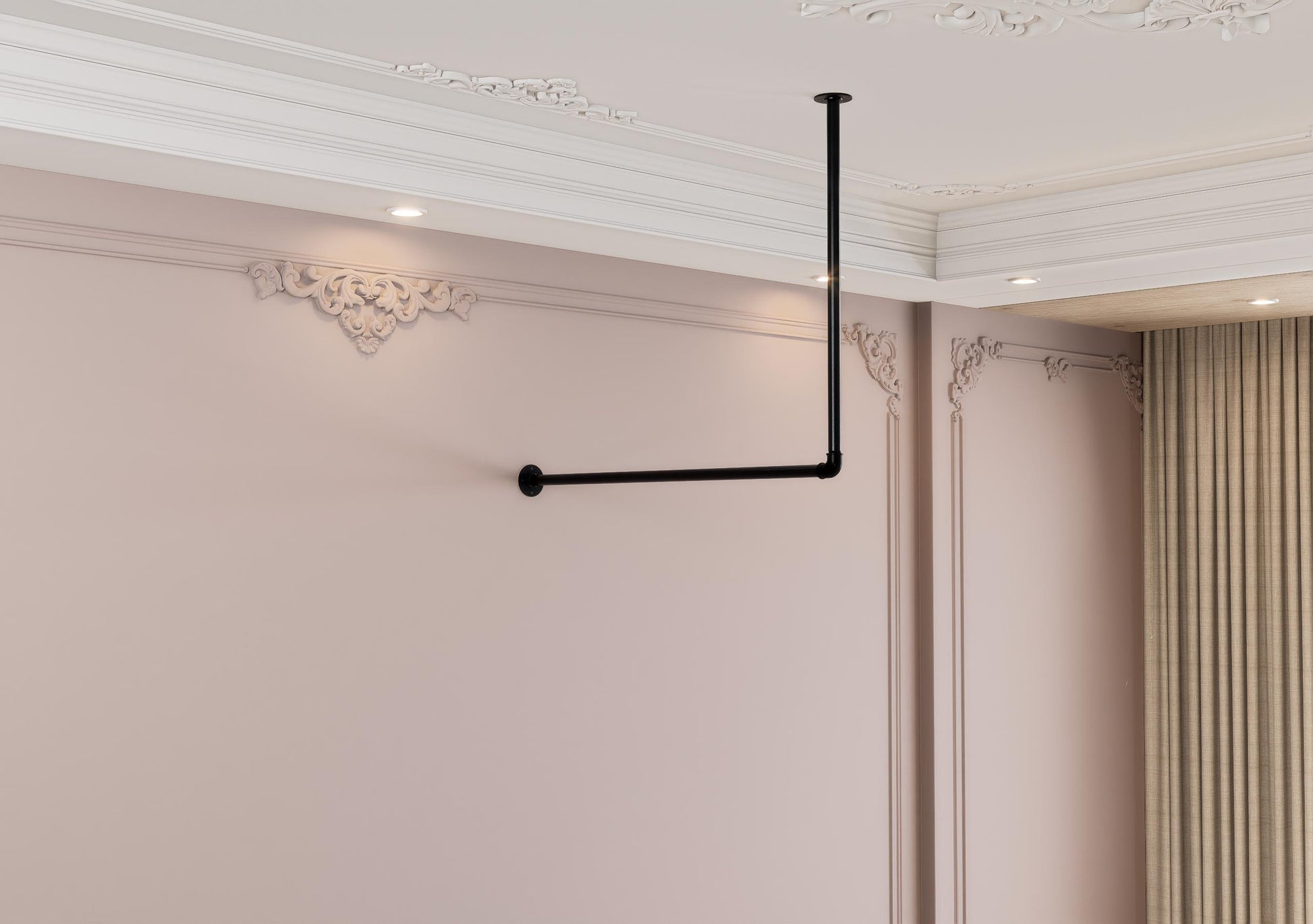 a room with pink walls and a black pipe