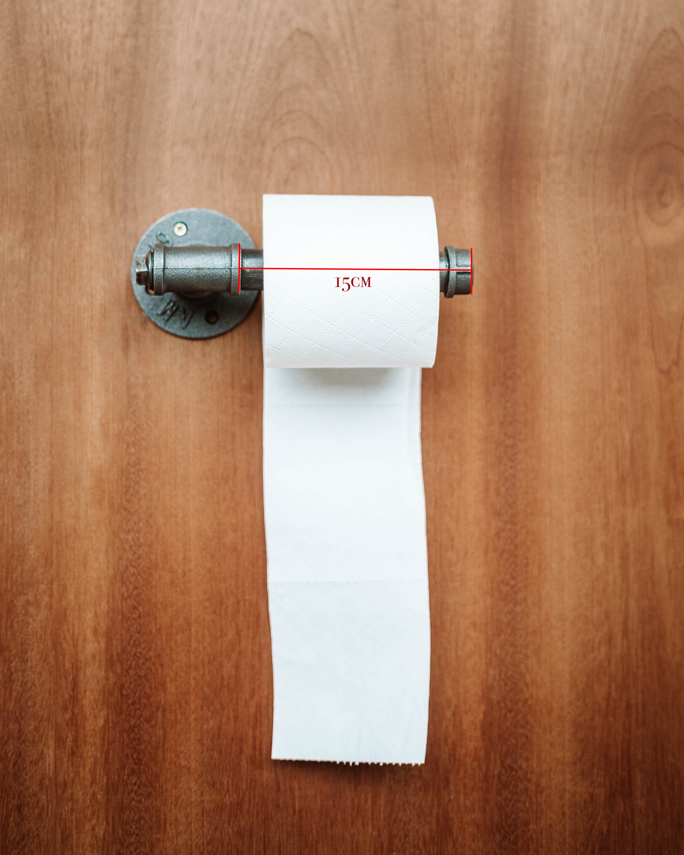 Contemporary Toilet Roll Holder holding toiletroll, highlighting its sleek and wall-mounted design.