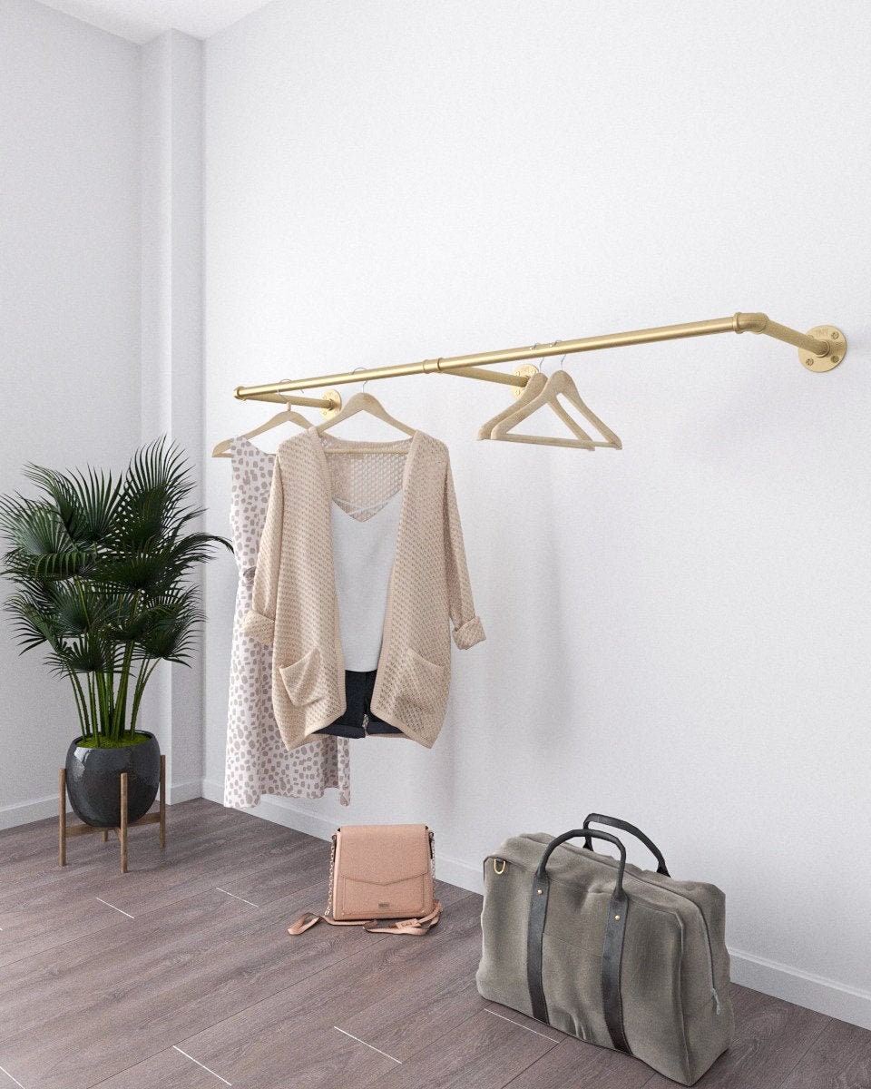 Arvuy Golden Wall Mounted Clothes Rack, an elegant and adjustable clothes rack with a golden finish, suitable for home organization or retail display