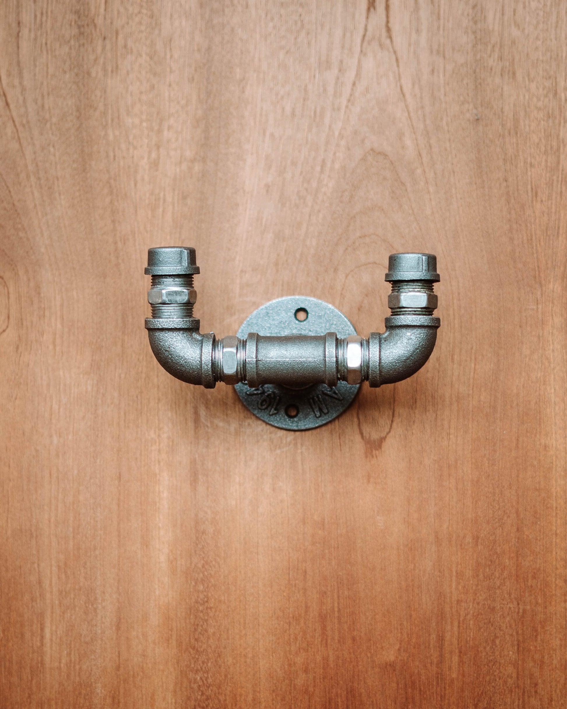 Industrial-style Pipe Coat Hanger Clothes Hook, ideal for organizing coats and accessories.